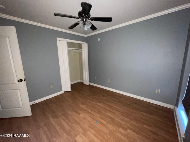 unfurnished bedroom featuring a closet, crown molding, ceiling fan, and dark wood-type flooring