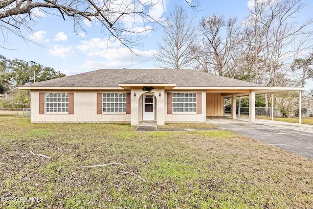 view of front of house with a front yard and a carport