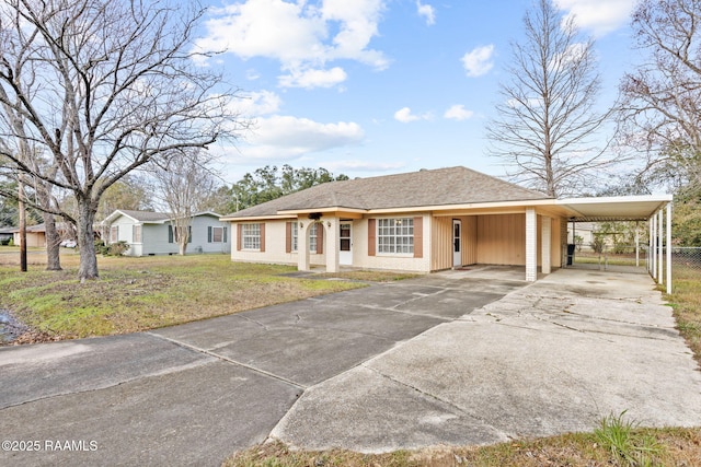 view of front of house with a carport and a front lawn