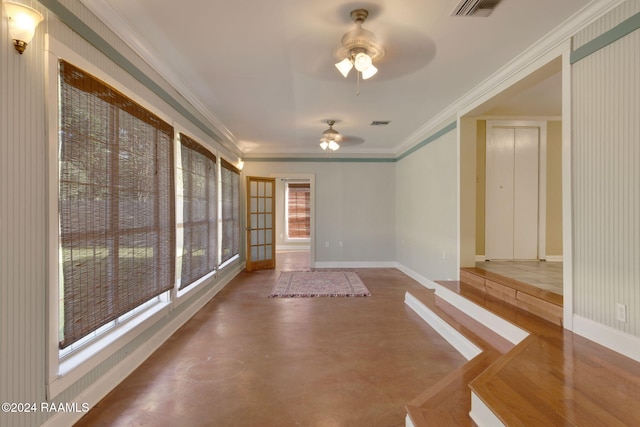 unfurnished sunroom with ceiling fan