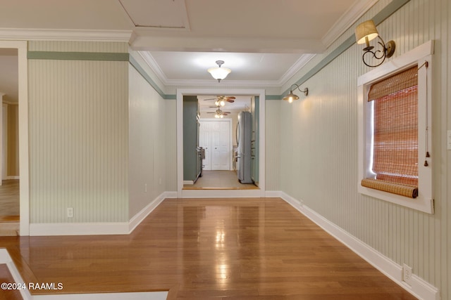 hall featuring wood-type flooring and ornamental molding