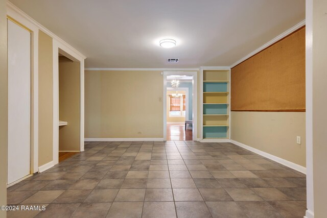 103 Brookside Dr, Lafayette, LA 70506 - empty room featuring a chandelier, ornamental molding, and tile patterned floors