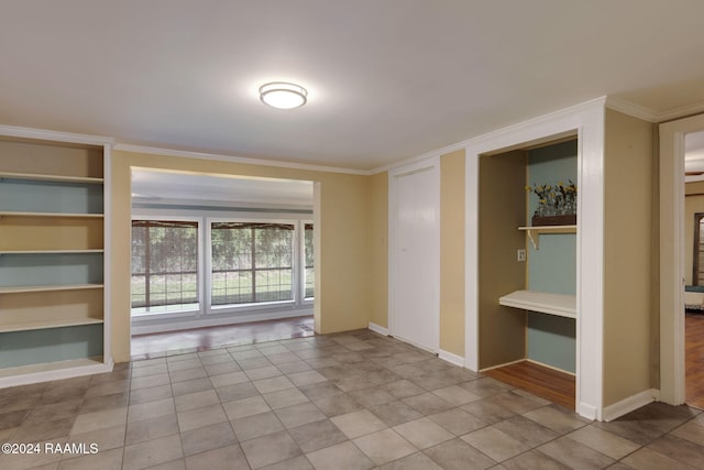 spare room with light tile patterned floors, built in features, and ornamental molding