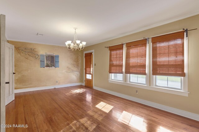 103 Brookside Dr, Lafayette, LA 70506 - unfurnished room featuring healthy amount of natural light, a chandelier, wood finished floors, and crown molding