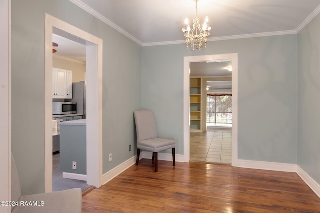 sitting room with crown molding, dark hardwood / wood-style flooring, and a chandelier