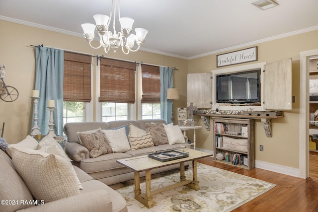 living room with crown molding, an inviting chandelier, and hardwood / wood-style flooring