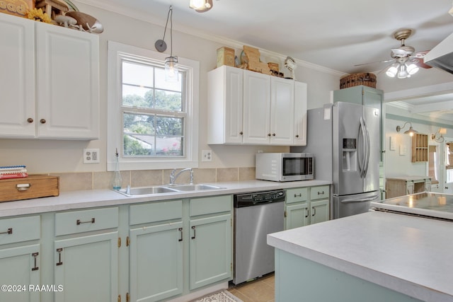 103 Brookside Dr, Lafayette, LA 70506 - kitchen featuring stainless steel appliances, ornamental molding, a ceiling fan, light countertops, and white cabinetry