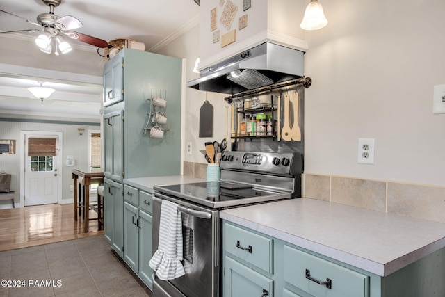 kitchen featuring ceiling fan, tile patterned flooring, island exhaust hood, crown molding, and stainless steel electric range