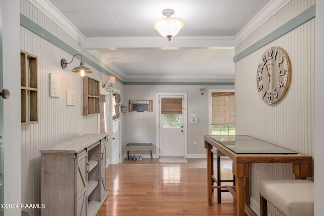 dining area with hardwood / wood-style flooring and ornamental molding