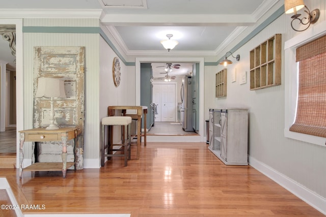 corridor with hardwood / wood-style floors and ornamental molding