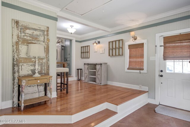 foyer featuring wood-type flooring and ornamental molding