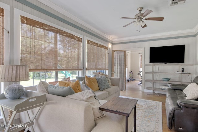 living room featuring light hardwood / wood-style floors, ceiling fan, and ornamental molding