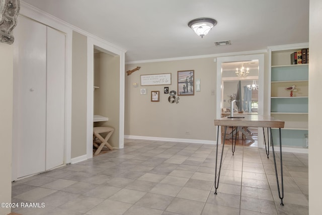 hallway with an inviting chandelier and ornamental molding