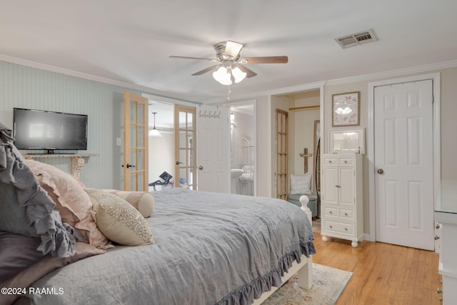 bedroom featuring ceiling fan, french doors, ensuite bathroom, light hardwood / wood-style floors, and ornamental molding