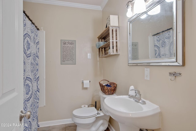 bathroom featuring toilet, tile patterned floors, ornamental molding, and sink