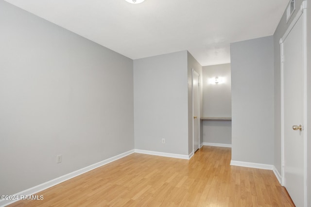 unfurnished bedroom with light hardwood / wood-style flooring and a closet