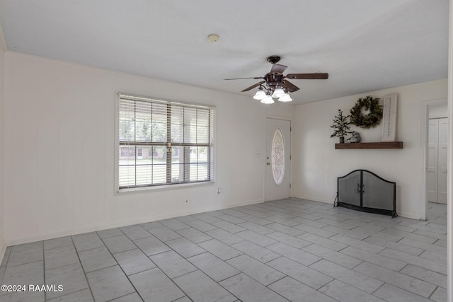 interior space featuring ceiling fan and light tile patterned floors