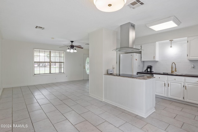 kitchen featuring white cabinets, sink, decorative backsplash, white fridge, and extractor fan