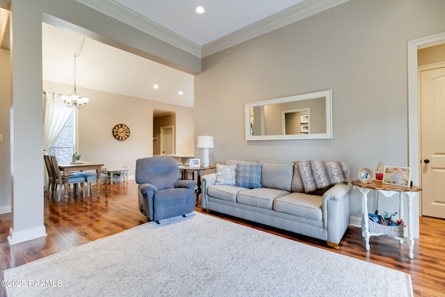 living room featuring hardwood / wood-style floors, a notable chandelier, and ornamental molding