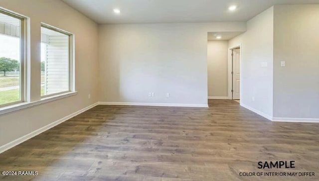 unfurnished room with dark hardwood / wood-style flooring