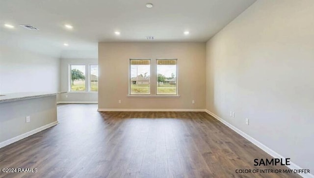 spare room with dark hardwood / wood-style floors