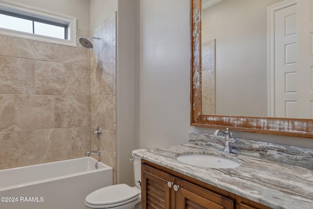 full bathroom with tiled shower / bath combo, toilet, and vanity