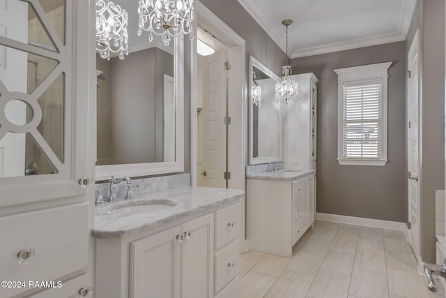 bathroom with crown molding, vanity, and a notable chandelier