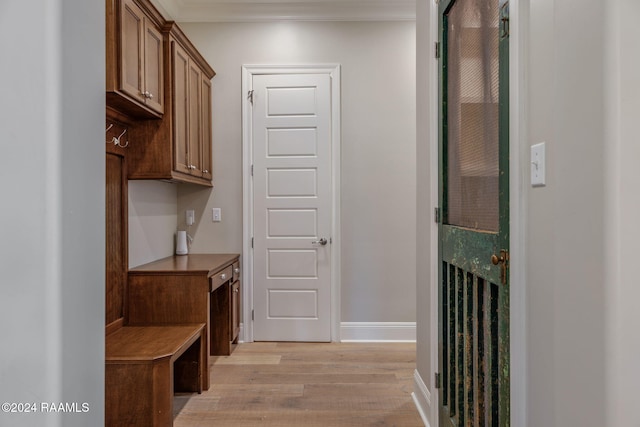 mudroom featuring light wood-type flooring and ornamental molding