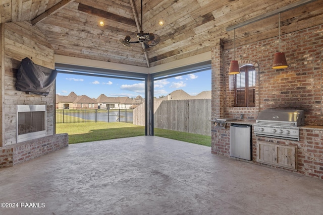 view of patio with a grill, area for grilling, and exterior fireplace