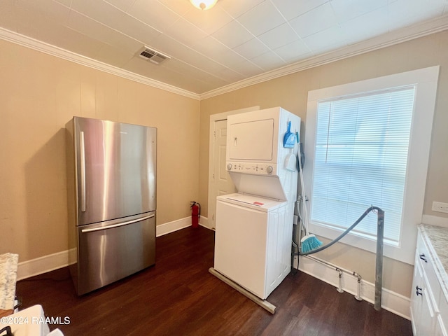 laundry room with stacked washer and dryer, dark hardwood / wood-style floors, and ornamental molding
