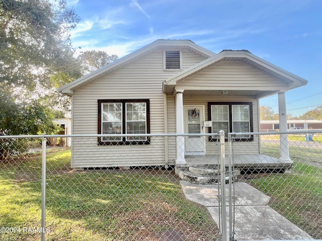 bungalow with a front lawn and covered porch