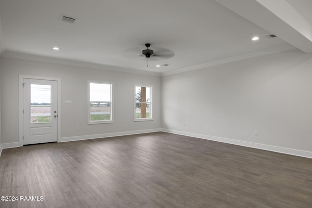 unfurnished living room featuring dark wood-type flooring, visible vents, plenty of natural light, and baseboards