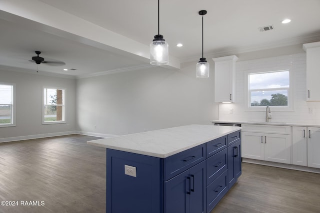 kitchen with white cabinets, open floor plan, a center island, blue cabinetry, and a sink