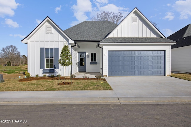 modern inspired farmhouse with a garage and a front yard