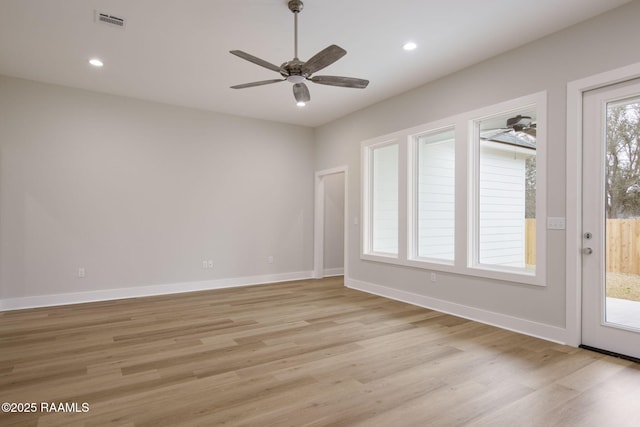 unfurnished room with ceiling fan and light wood-type flooring