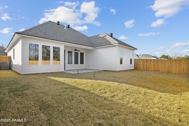 rear view of property with ceiling fan, central air condition unit, a patio area, and a lawn