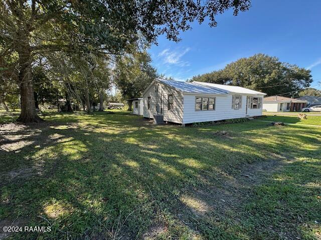 view of property exterior with a yard