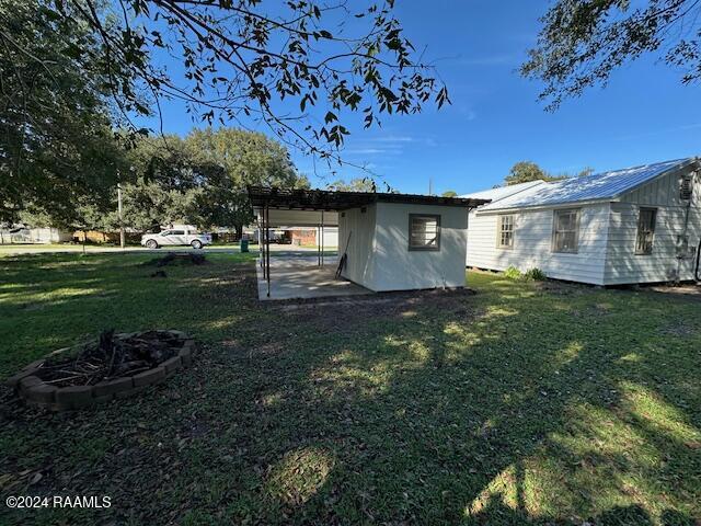 view of yard featuring an outbuilding and a carport