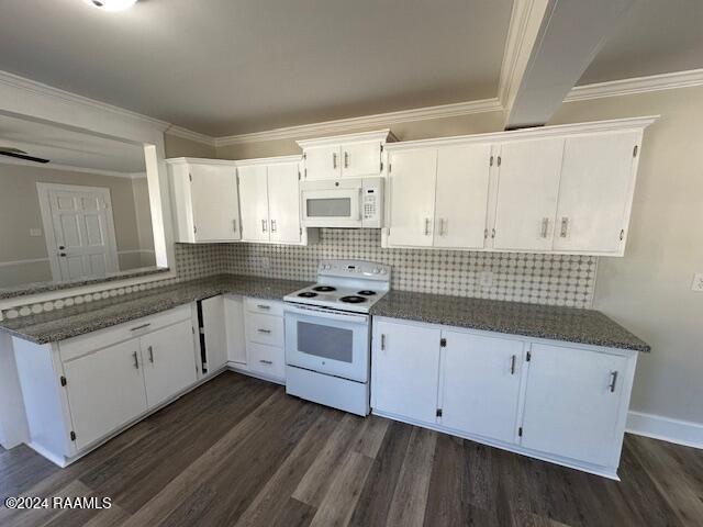 kitchen with dark hardwood / wood-style flooring, tasteful backsplash, white appliances, dark stone countertops, and white cabinetry