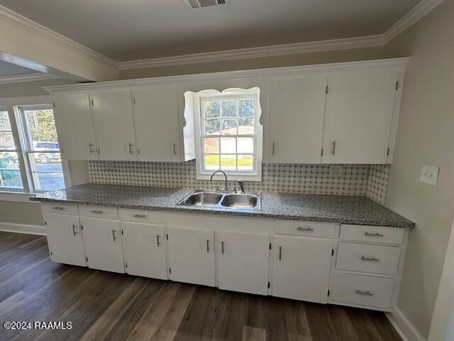 1722 Michael St, Abbeville, LA 70510 - kitchen featuring dark wood finished floors, white cabinets, ornamental molding, and tasteful backsplash
