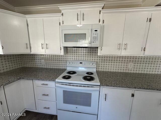 1722 Michael St, Abbeville, LA 70510 - kitchen featuring white appliances, white cabinets, backsplash, and crown molding