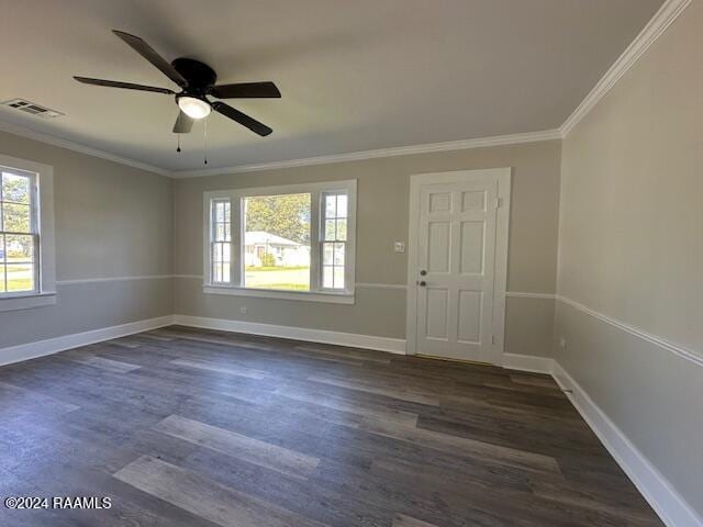 entrance foyer featuring dark hardwood / wood-style flooring, a wealth of natural light, crown molding, and ceiling fan