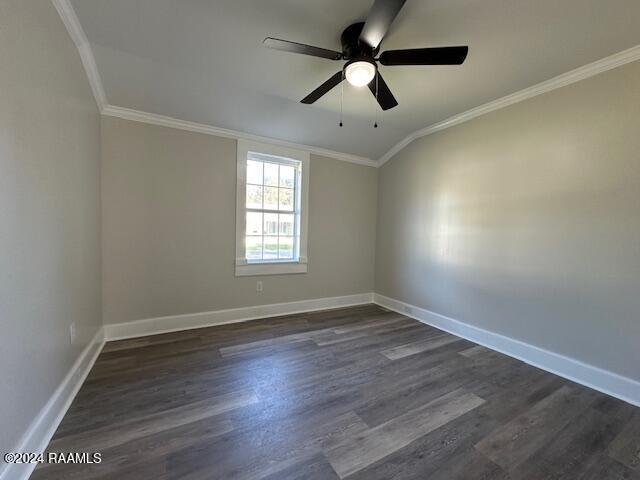 unfurnished room with ceiling fan, crown molding, and dark wood-type flooring