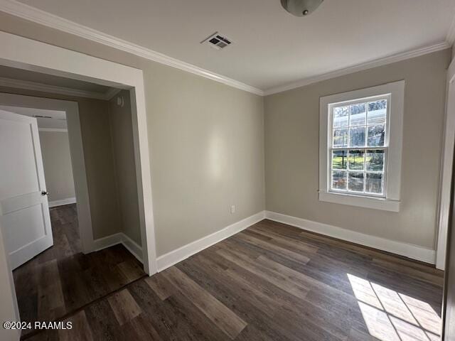 unfurnished room with dark wood-type flooring and ornamental molding