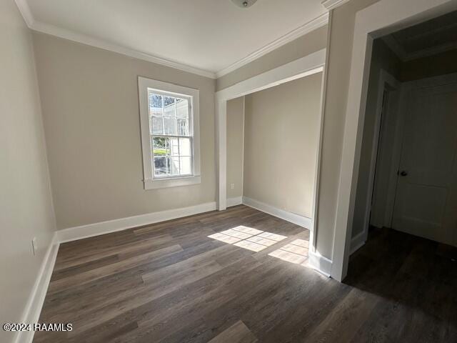 unfurnished bedroom featuring dark hardwood / wood-style floors, ornamental molding, and a closet