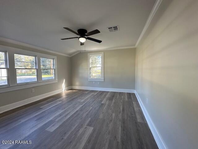 empty room featuring ornamental molding, vaulted ceiling, ceiling fan, and dark wood-type flooring