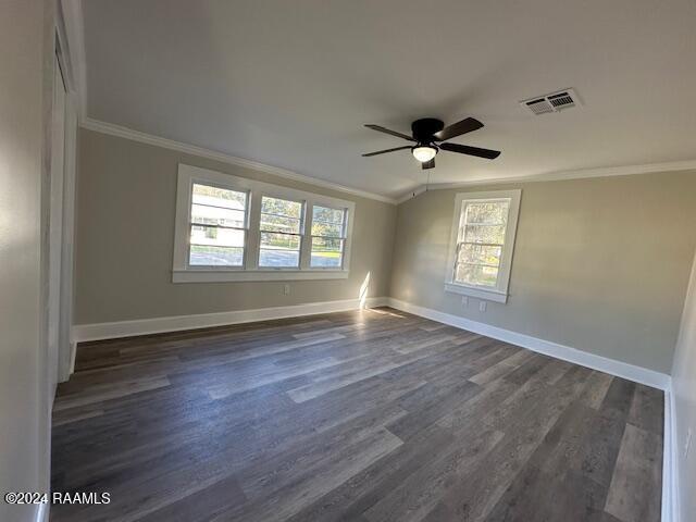 unfurnished room featuring lofted ceiling, ceiling fan, dark hardwood / wood-style floors, and ornamental molding