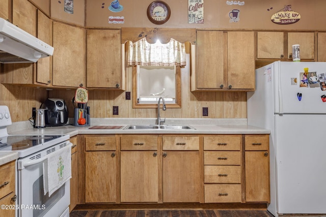 kitchen with white appliances, wooden walls, dark hardwood / wood-style flooring, and sink