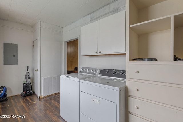 laundry area with electric panel, dark wood-type flooring, cabinets, and washing machine and dryer