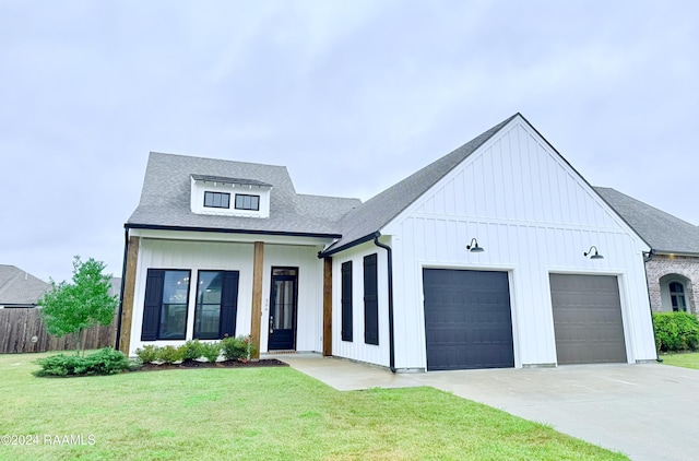 modern farmhouse style home featuring a front yard and a garage